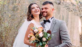 Bridegroom and bride laughing during daytime visual for wedding photo editing services