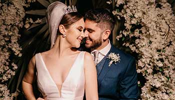 Wedding photo editing visual bridegroom in blue suit kissing bride in white sleeveless dress edited