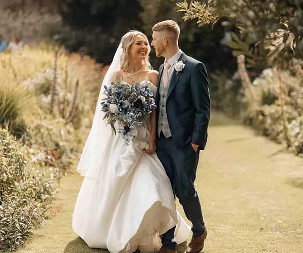Bride and groom standing in a garden wedding photo editing after visual