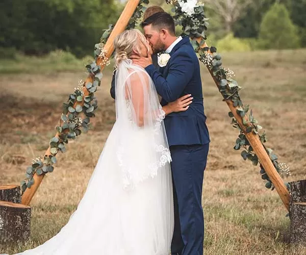 Wedding photo editing after visual bride and groom kissing on grass field during daytime
