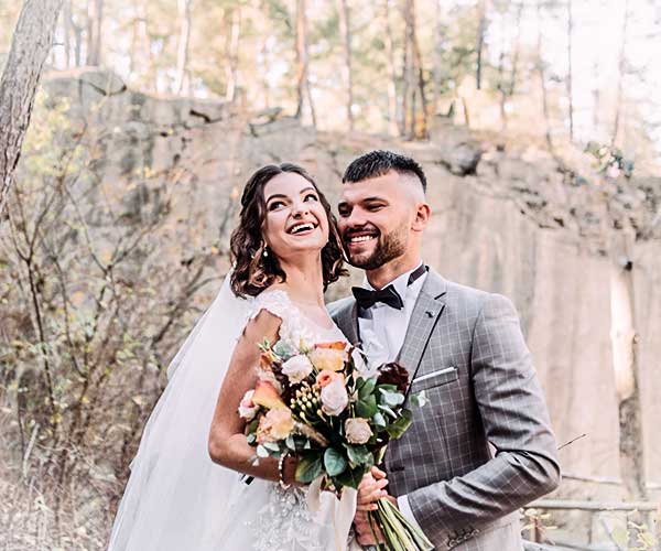 Wedding photo editing before visual man and woman both laughing by tree during daytime