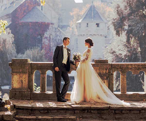 Wedding photo editing before visual woman in white wedding dress stands in front of man in tuxedo