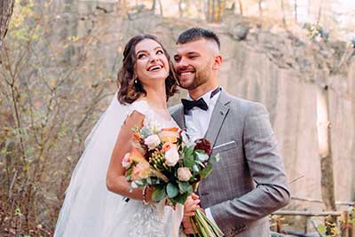 Wedding photo editing services visual man and woman both laughing by tree during daytime